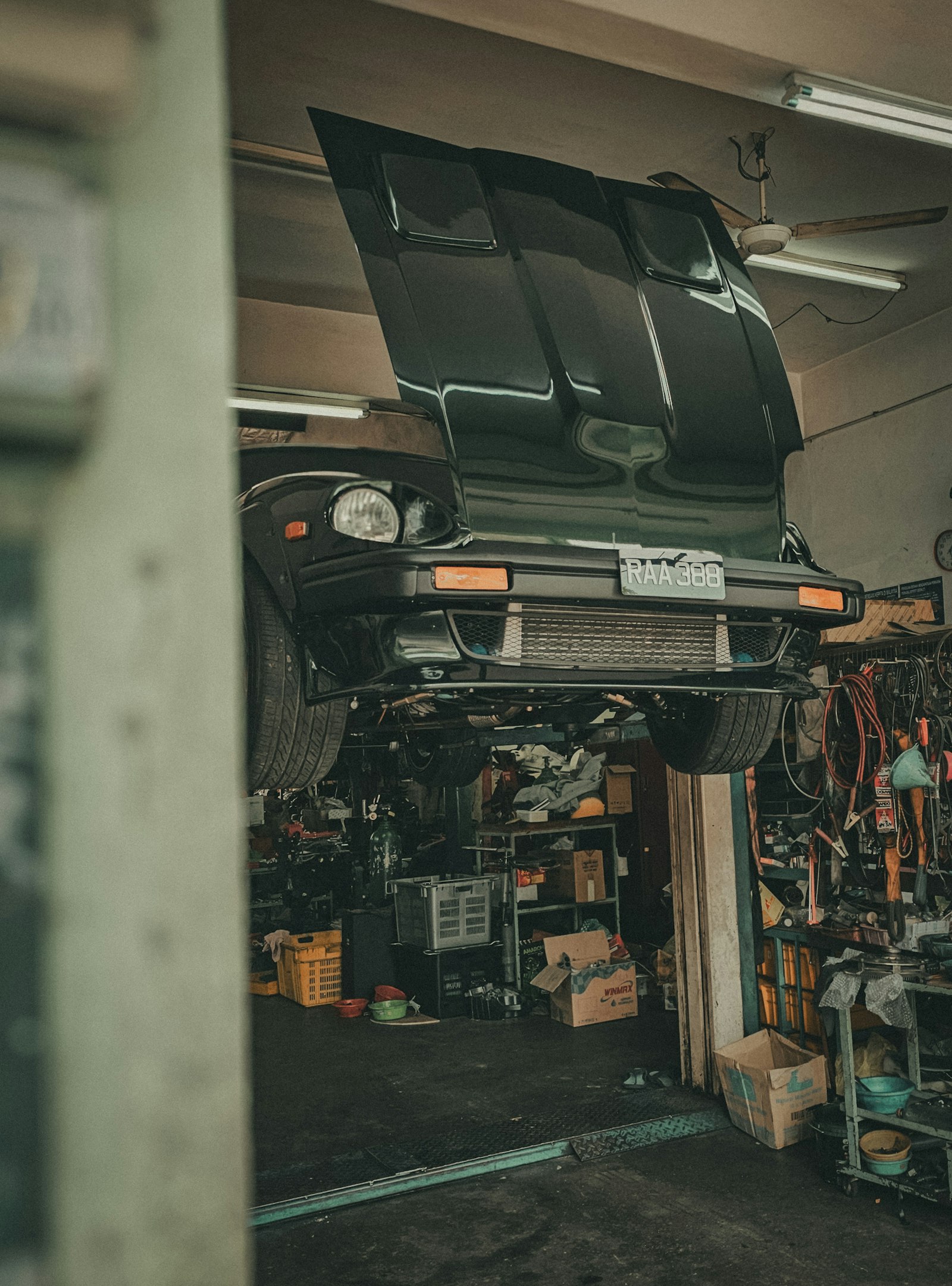 An empty collision repair workshop with vehicle lifts, tool cabinets, and clean floors under even overhead lighting.