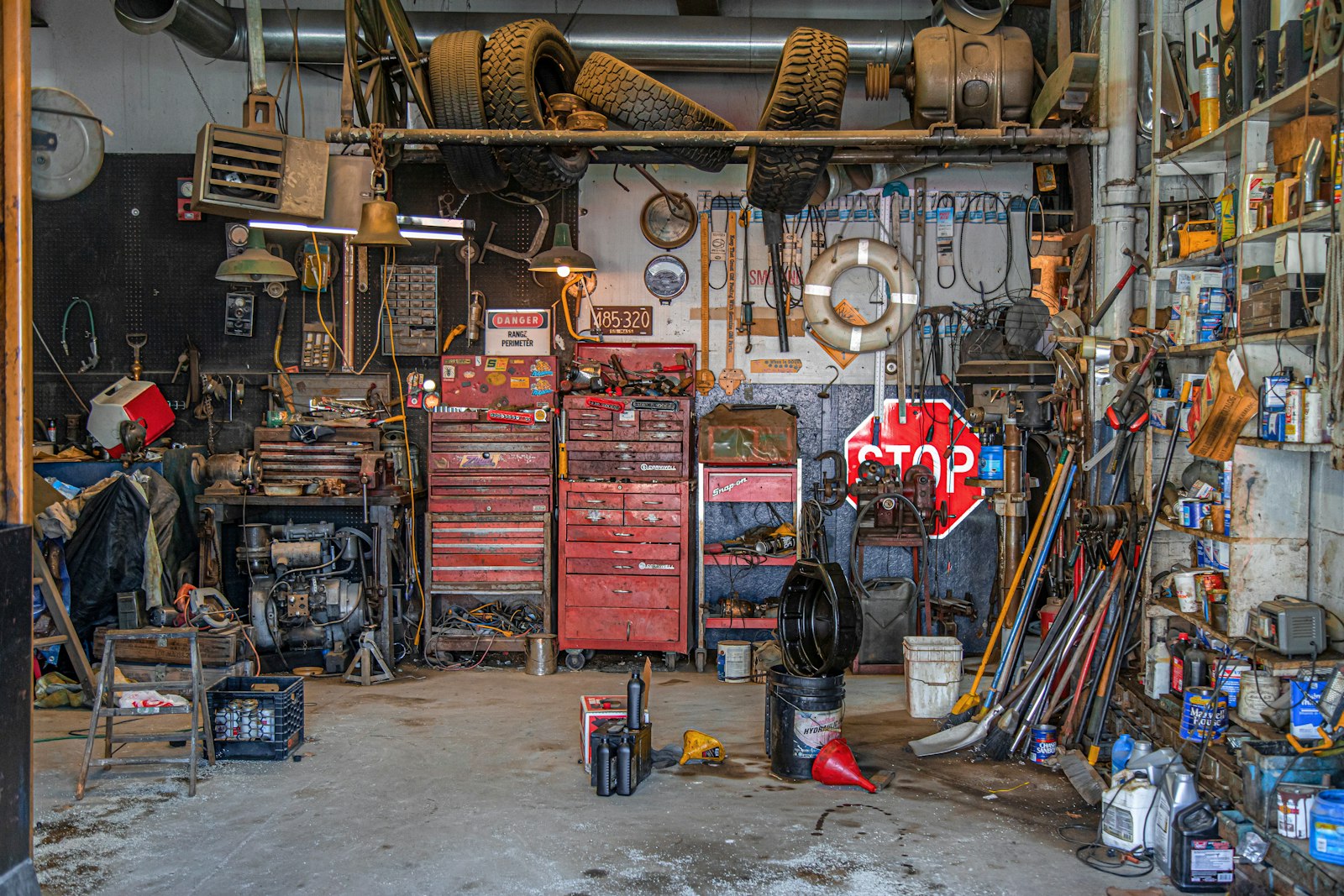 A body shop workbench holding removed exterior car panels and labeled fasteners laid out for inspection.