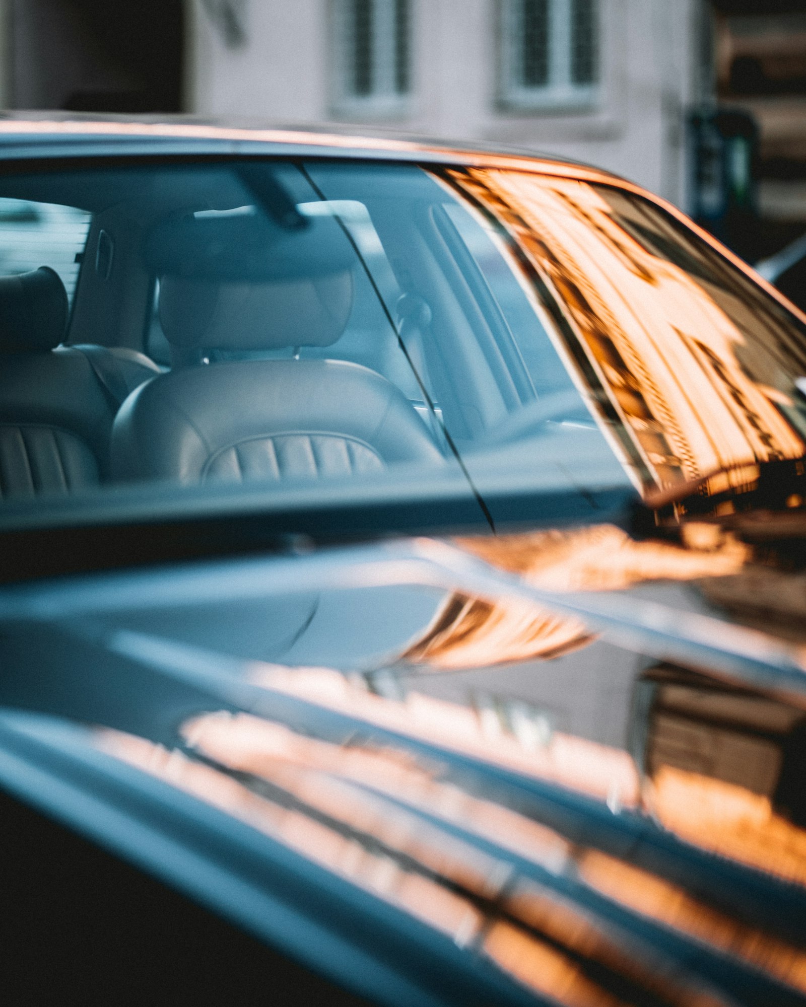 A close view of glass and dark bodywork on a vehicle.