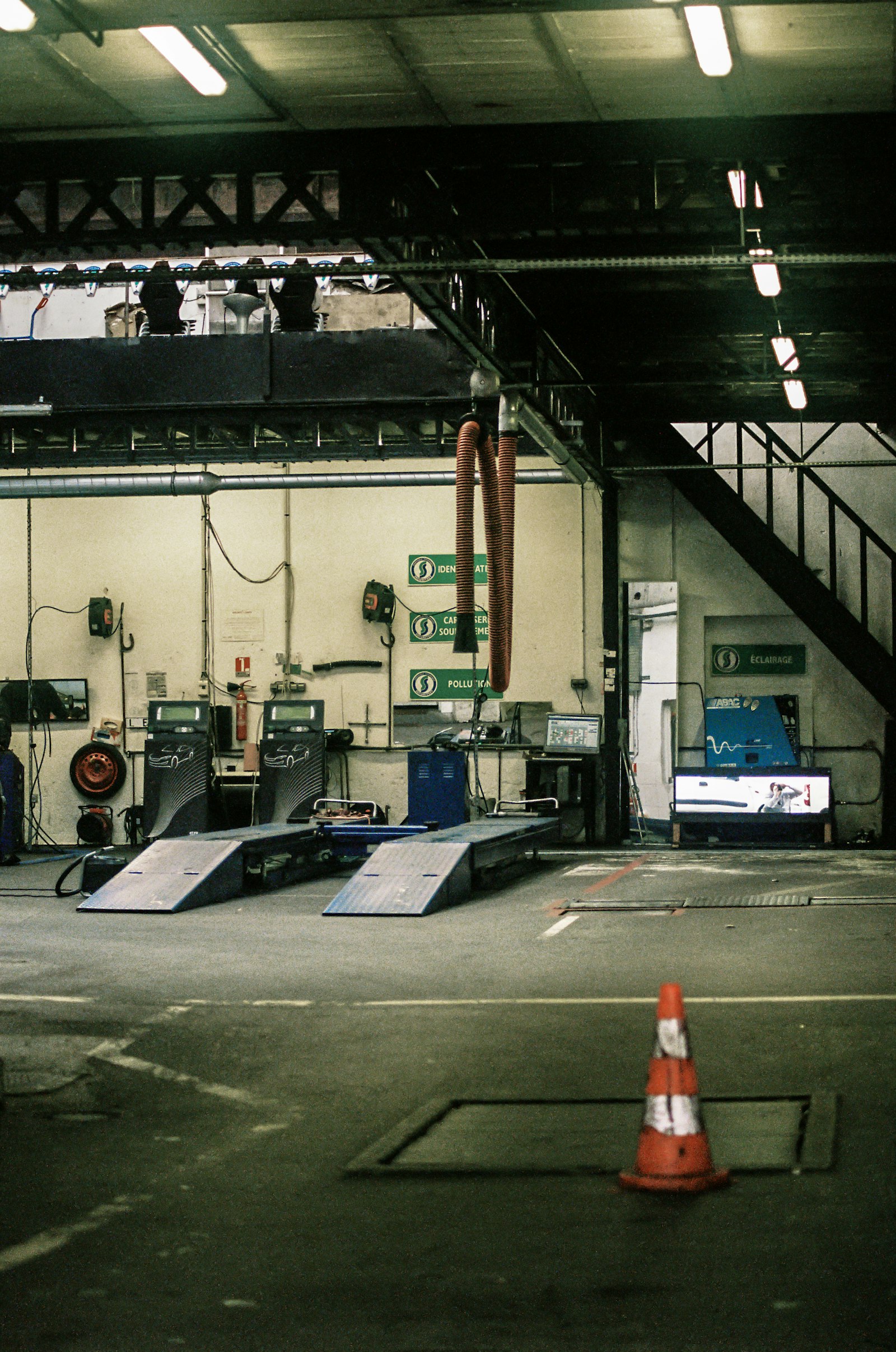 A service workshop interior with ramps and equipment along the wall.